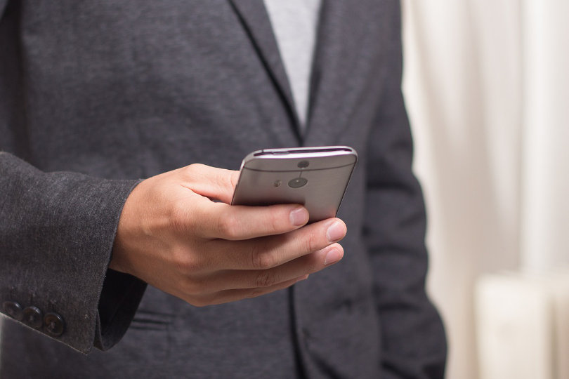 A businessman is using smartphone for browsing