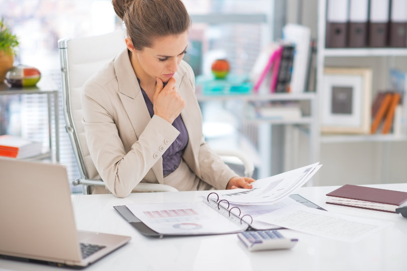 Businesswoman analyzing financial reports