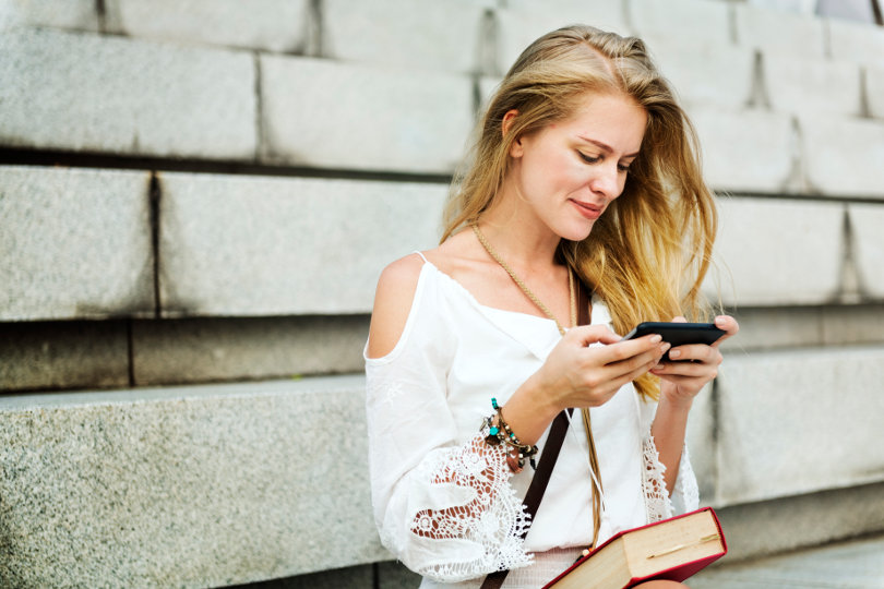 Woman watching TV streaming on her smartphone