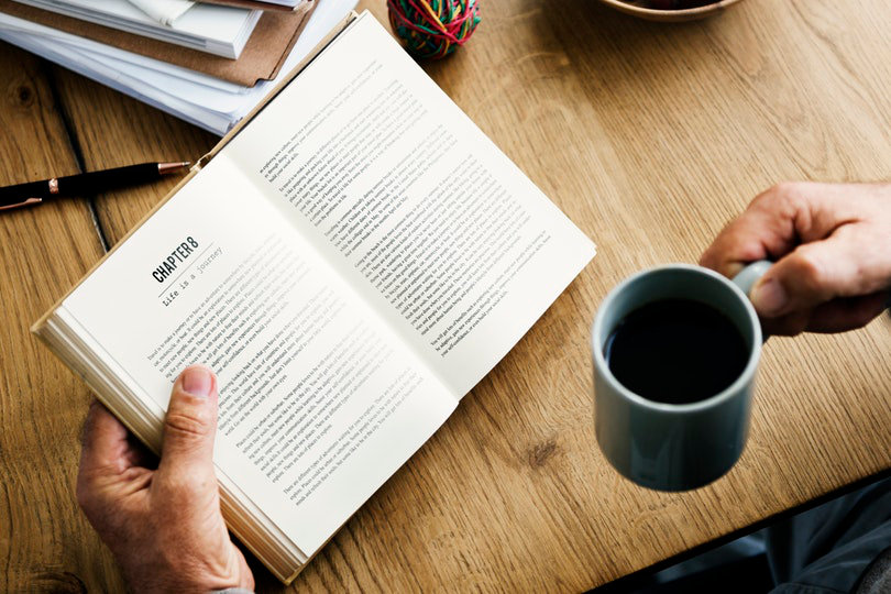 Reading book and drinking coffee