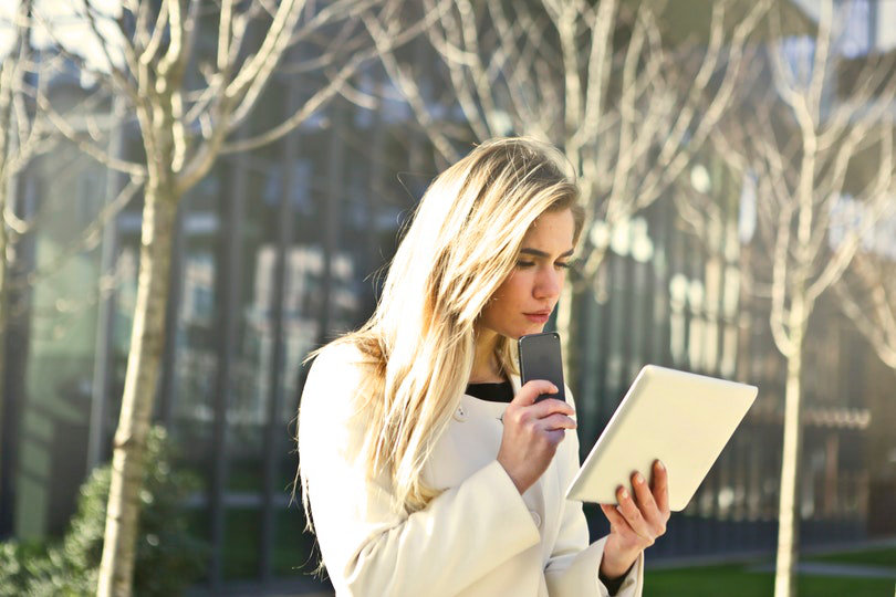 Busy businesswoman with her gadgets