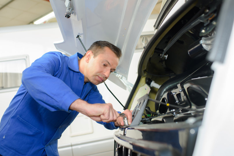 Fleet mechanic working on van repair