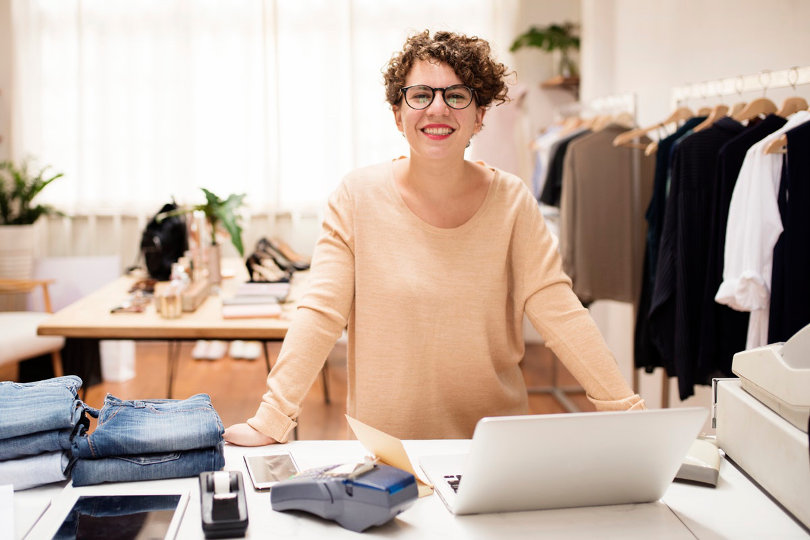 Clothing business owner smiling