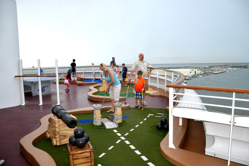 Family playing mini golf