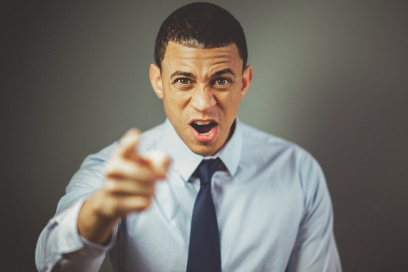 Angry boss discriminating employee