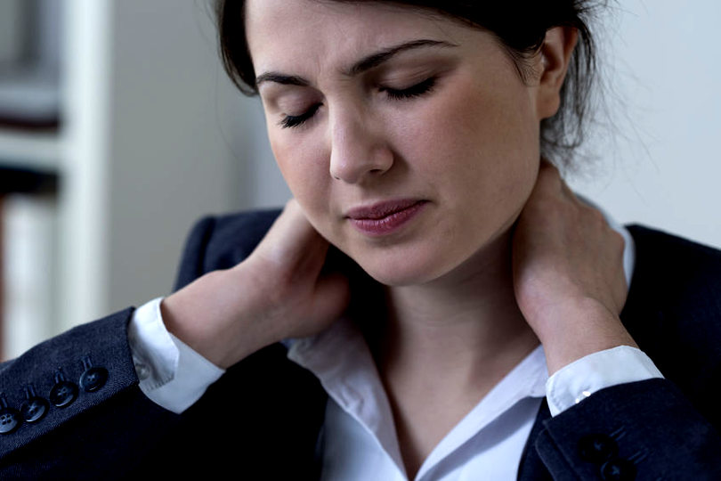 Businesswoman having neck pain