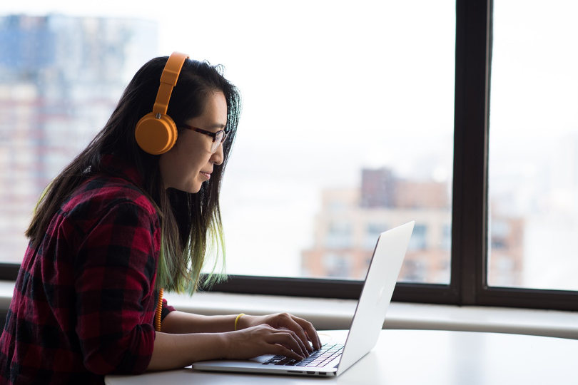 Employee wearing headphone accessing audio content