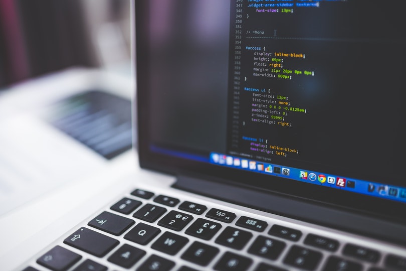 Laptop with code editor on screen