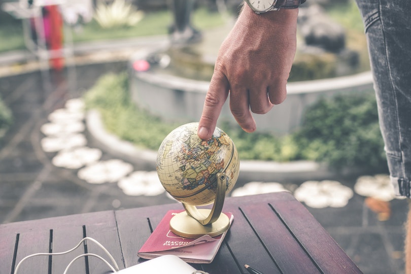 Man spinning small globe
