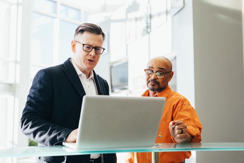 Startup manager collaborating on computer with team