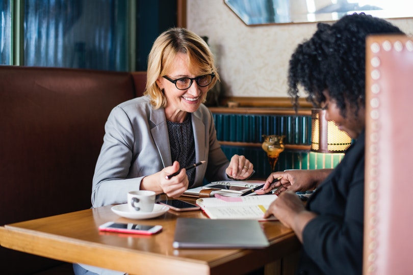 Business owner entertaining important customer at cafe