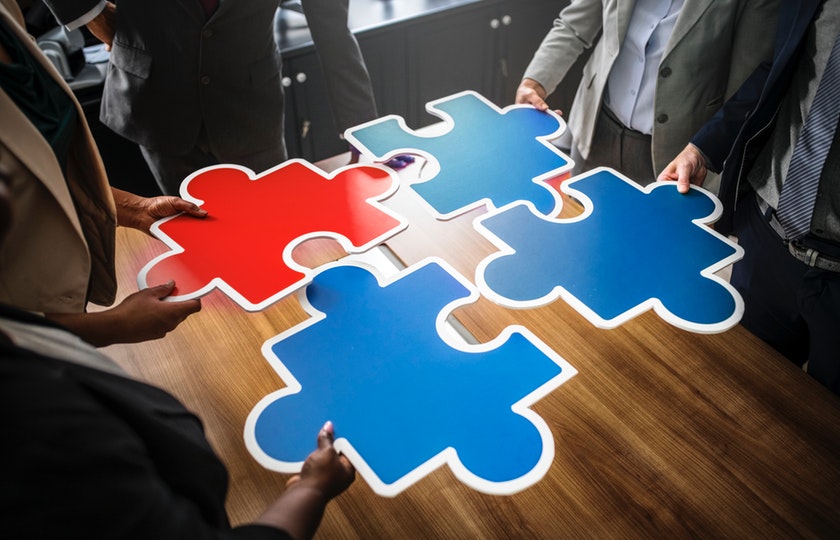 Team collaborating to piece a puzzle together