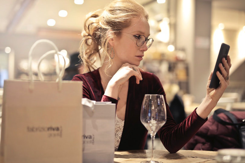 Shopper using a smartphone while sitting