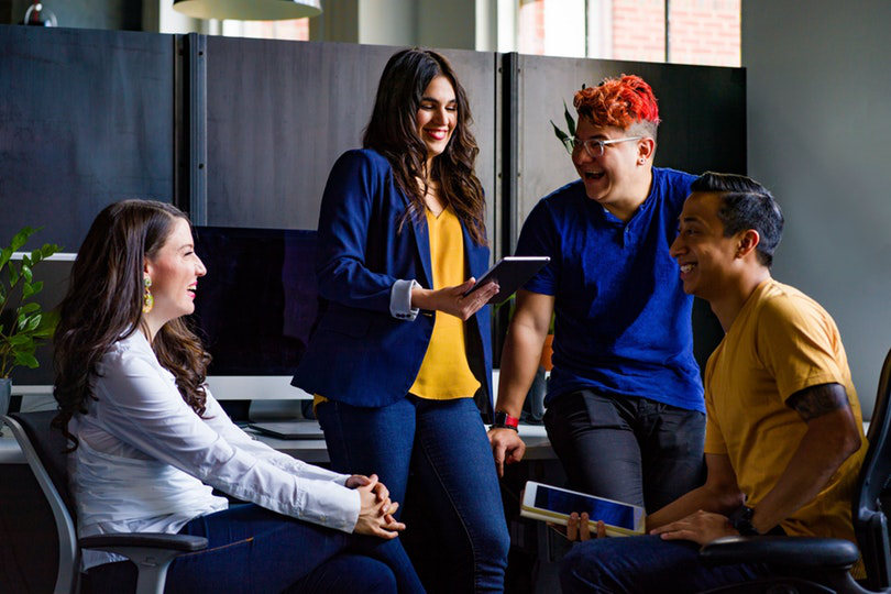 Colleagues conversing in office