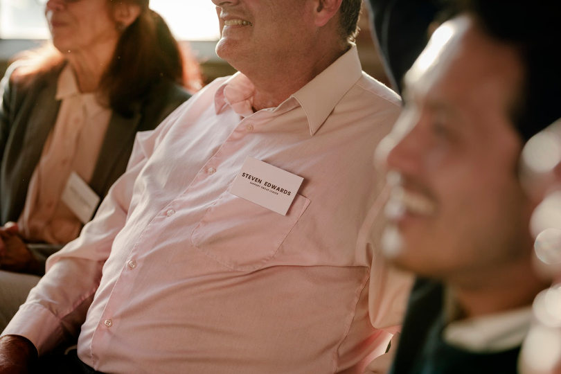 Employees wearing name tags in a meeting