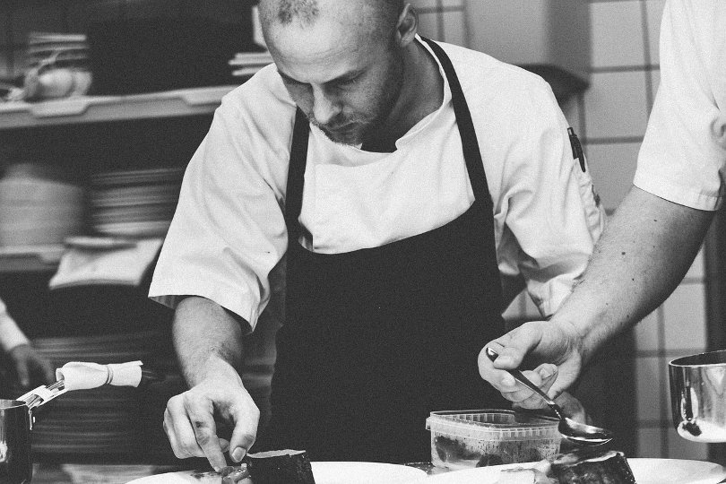 Kitchen hand helping the chef