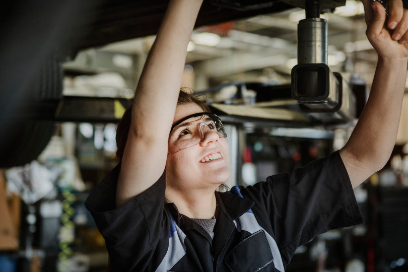 A mechanic servicing a car