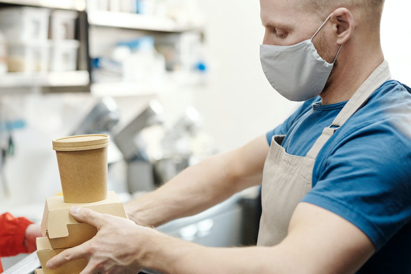 Restaurant owner packing food to go