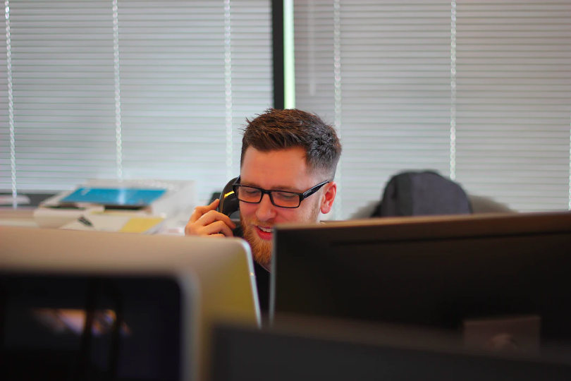 Customer service staff serving a client via phone