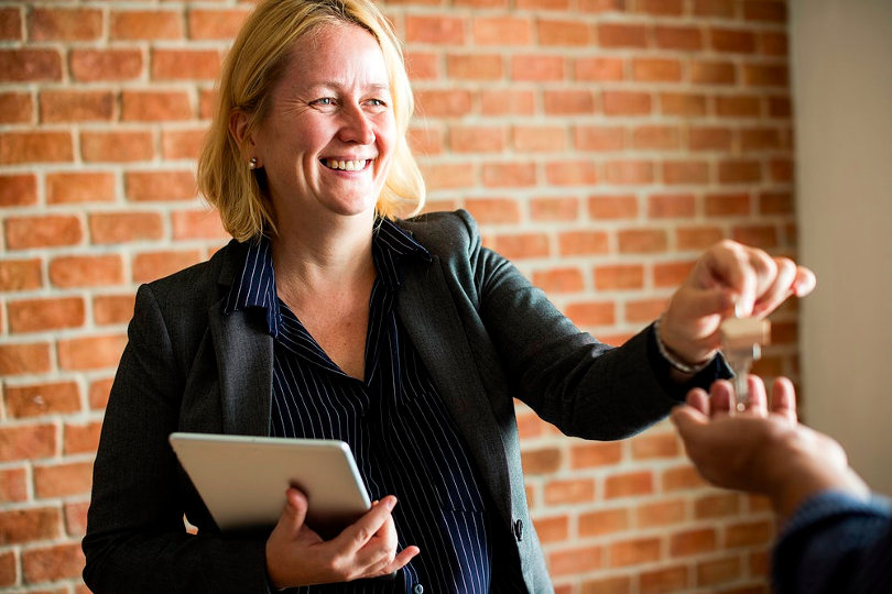 Real estate agent giving buyer the key