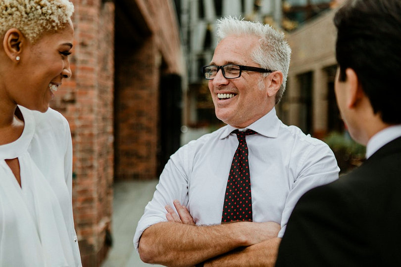 Friendly boss talking with employees