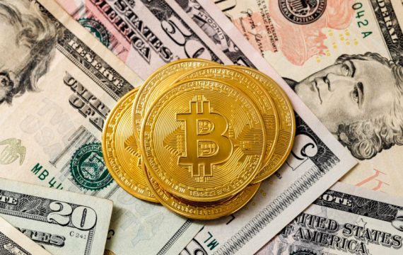 Bitcoin and dollar bills