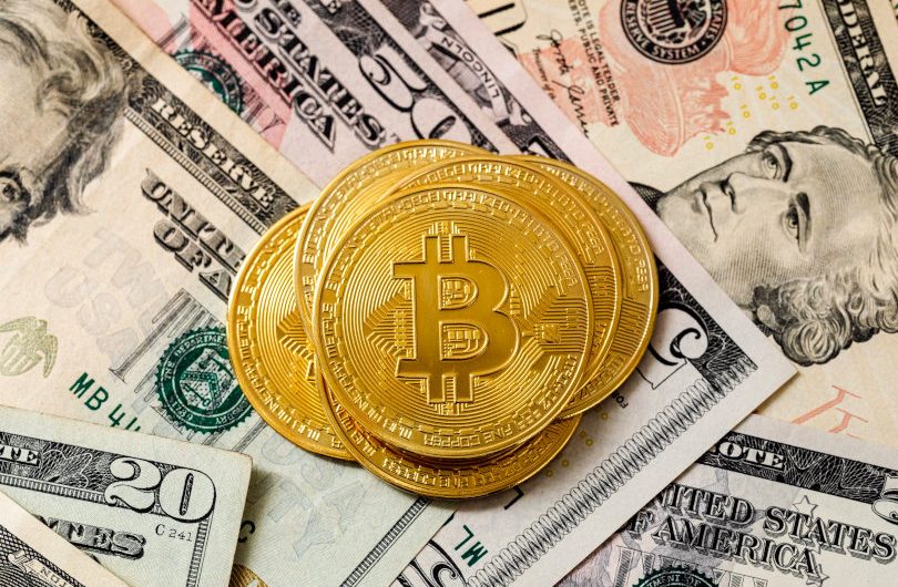 Bitcoin and dollar bills