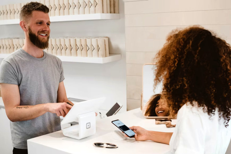 Business owner processing payment for a customer