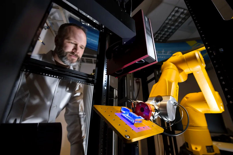 Robot arm inspecting 3D printed material