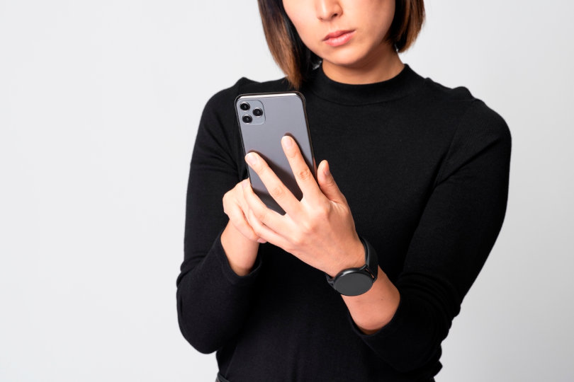 Businesswoman using smartphone app