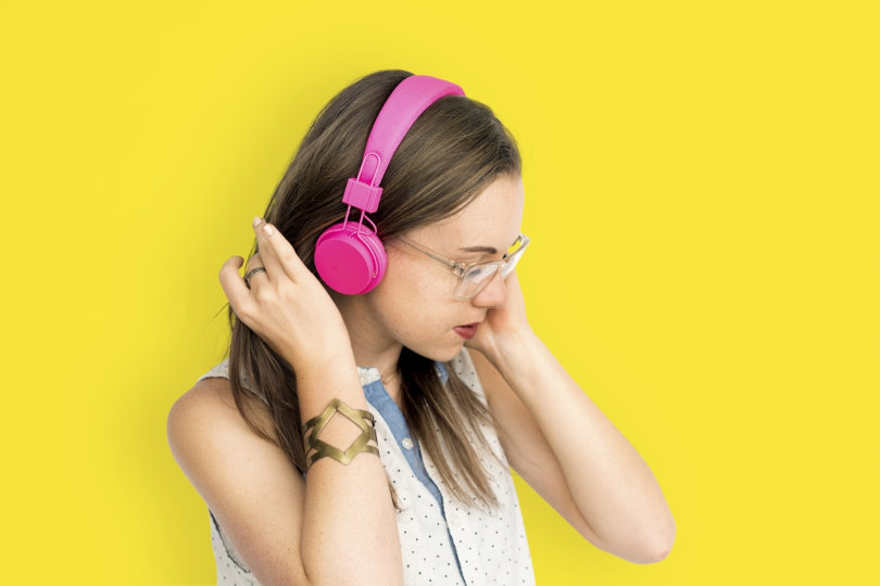 Young woman listening to music via Soundcloud