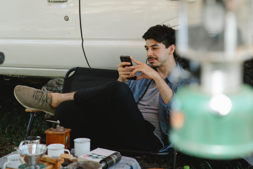 Man in the campground using smartphone